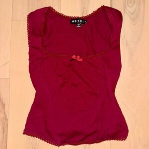 Motel rocks red corset top with lace trim and small bow.